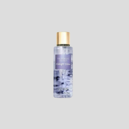 A 250ml bottle of Victoria's Secret Midnight Bloom Body Mist, featuring a dark, elegant design with a floral pattern on the label. The mist is a deep purple hue, symbolizing the richness and mystery of the fragrance. The bottle is set against a soft gradient background to highlight its luxurious appeal and the captivating scent it holds.

