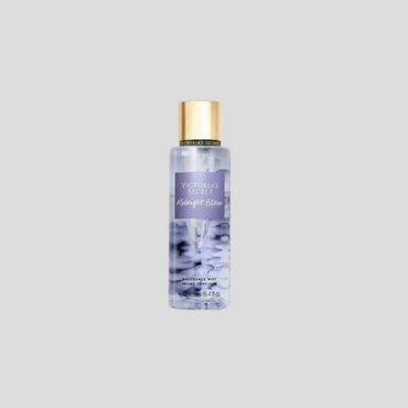 A 250ml bottle of Victoria's Secret Midnight Bloom Body Mist, featuring a dark, elegant design with a floral pattern on the label. The mist is a deep purple hue, symbolizing the richness and mystery of the fragrance. The bottle is set against a soft gradient background to highlight its luxurious appeal and the captivating scent it holds.

