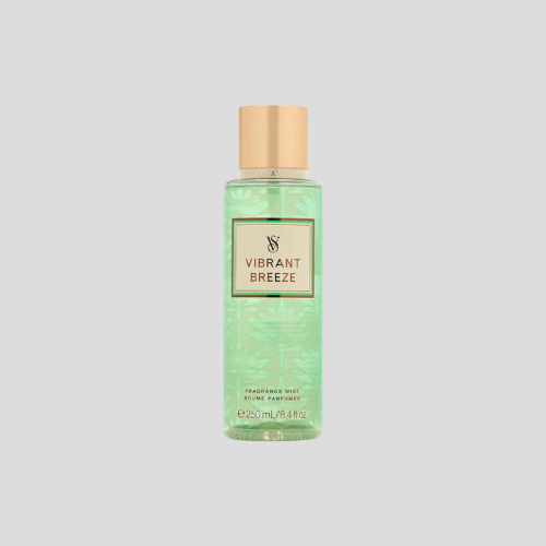 A 250ml bottle of Victoria's Secret Vibrant Breeze Fragrance Mist, featuring a sleek, transparent bottle with a vibrant tropical design. The mist is a soft pink hue, and the label displays the Victoria's Secret logo and product details. The bottle is positioned against a soft, neutral background to emphasize its elegance and refreshing fragrance.
