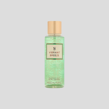 A 250ml bottle of Victoria's Secret Vibrant Breeze Fragrance Mist, featuring a sleek, transparent bottle with a vibrant tropical design. The mist is a soft pink hue, and the label displays the Victoria's Secret logo and product details. The bottle is positioned against a soft, neutral background to emphasize its elegance and refreshing fragrance.
